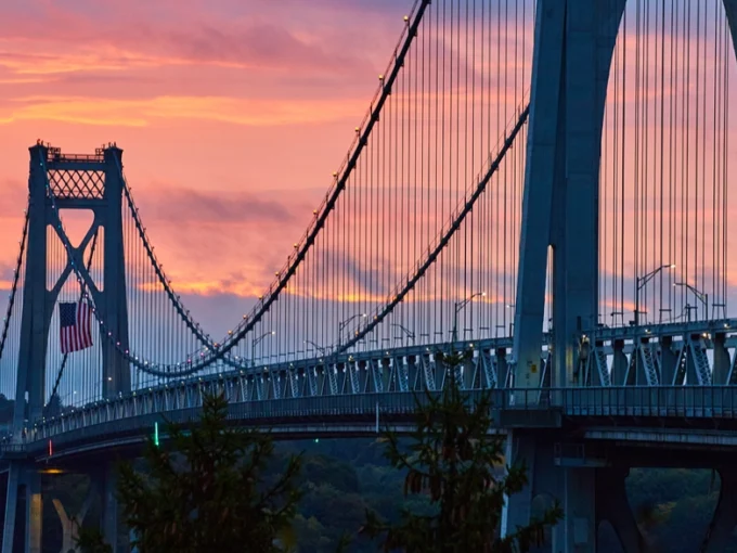 Hudson Valley bridge silhouetted against a sunset sky