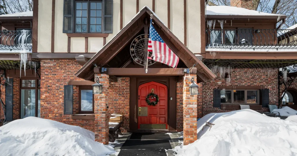 Westchester Castle luxury wedding venue dusted in falling snow during a winter day in the Hudson Valley